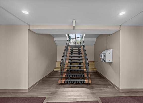 A staircase with a metal railing at Kensington House, Kensington, Maryland