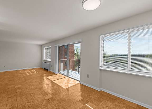 A room with a sliding glass door leading to a balcony at Kensington House, Maryland 20895