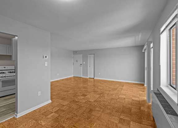 A room with wooden flooring and white walls at Kensington House, Kensington, MD 20895