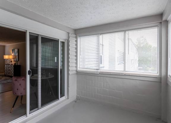 A room with a sliding glass door leading to a balcony at The Lawrence Apartments, Greenbelt, MD 20770