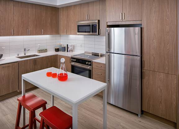 Our kitchens feature stainless steel appliances, tile backsplash and wood-grain cabinets