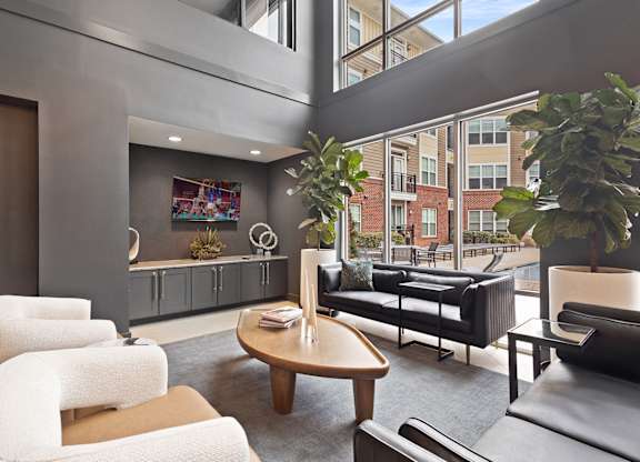 A living room with a couch, chairs, and a table.