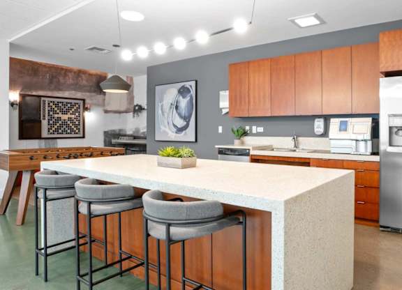 A modern kitchen with a bar area and stools.