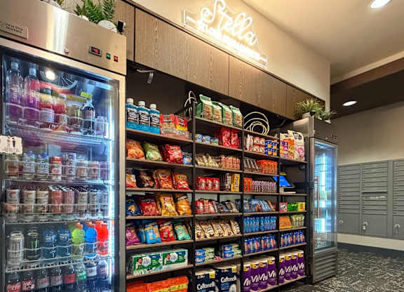 A vending machine with a variety of drinks and snacks.