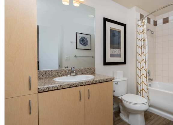 A bathroom with a white toilet, sink, and bathtub.