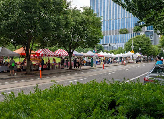 A street scene with a market on the side.