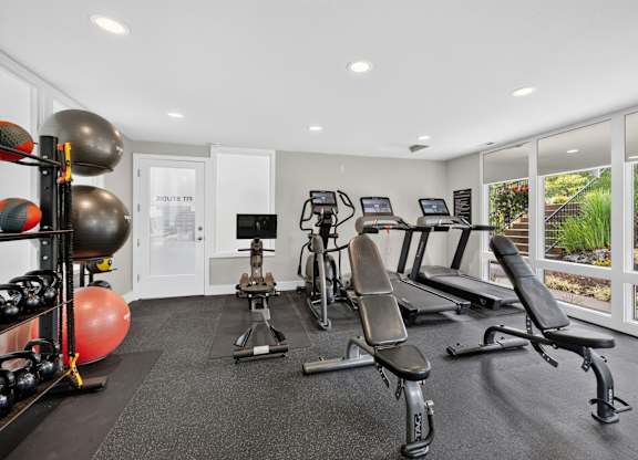 A well-equipped home gym with a variety of exercise equipment.