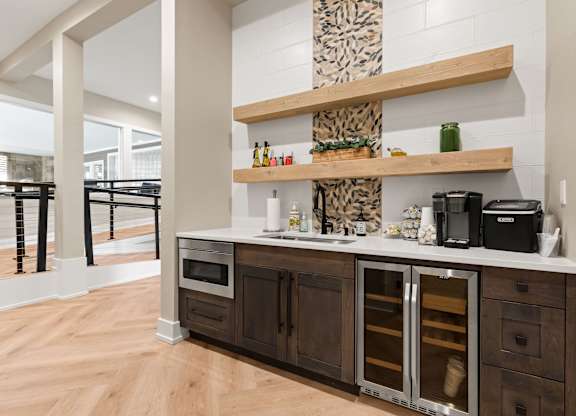 A kitchen with a wooden floor and a white wall.