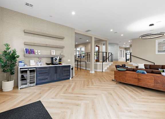 A well-lit, spacious interior with wooden flooring and a variety of furniture and decor.