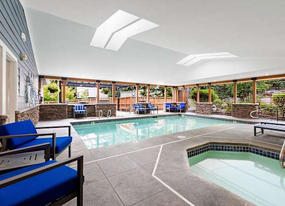 A large indoor swimming pool with a slide.