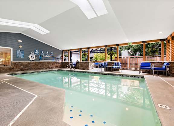 A large indoor swimming pool with a glass bottom.