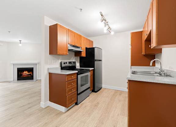 A kitchen with brown cabinets and a white counter.