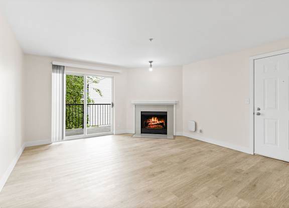 A room with a fireplace and sliding glass doors.