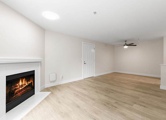 A room with a fireplace and a ceiling fan.