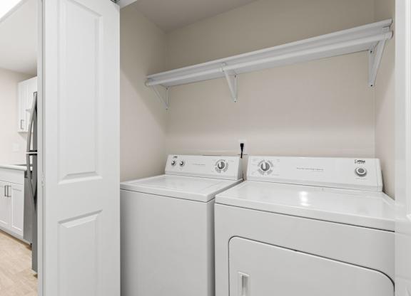 A white laundry room with a washer and dryer.