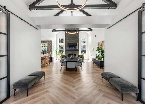 A modern living room with a wooden floor and a large window.