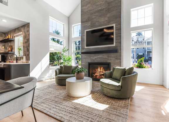 A living room with a fireplace and a television above it.