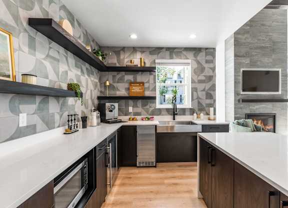 A modern kitchen with a stone backsplash and dark wood cabinets.