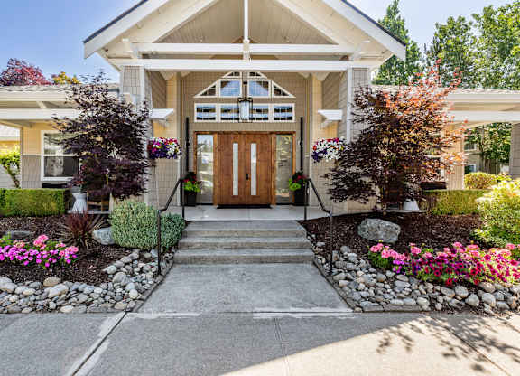 A house with a front yard and a stone pathway leading to the front door.