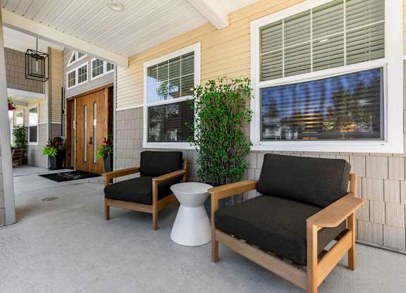 A patio with a chair and a table.
