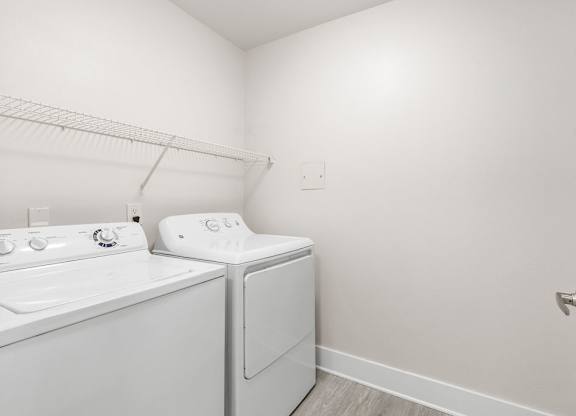 A white washer and dryer in a small laundry room.