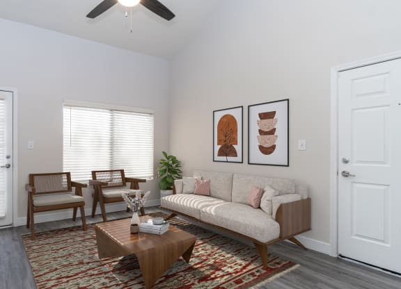 a living room with two windows and a ceiling fan