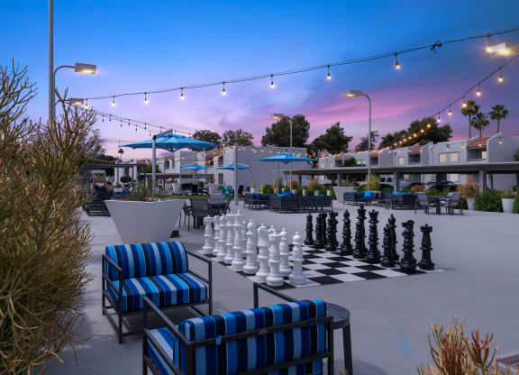 a giant chess board is set up on a patio