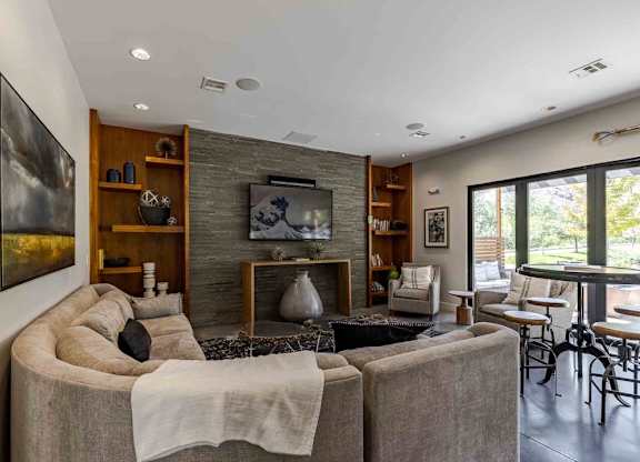 A modern living room with a large couch and a fireplace.