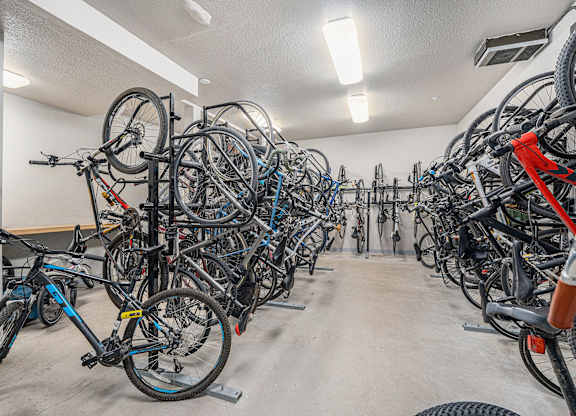 A bike parking room with many bikes.