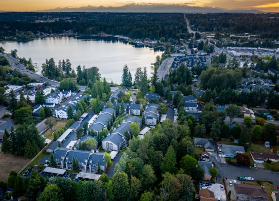 arial view of a neighborhood with a lake in the background
