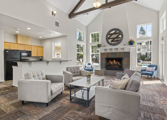 a living room with couches and chairs and a fireplace