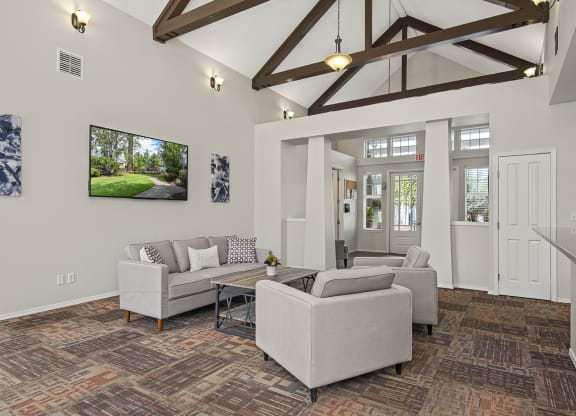 a living room with couches and chairs and a table