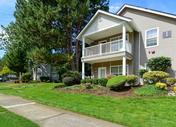 a house with a porch and a sidewalk in front of it