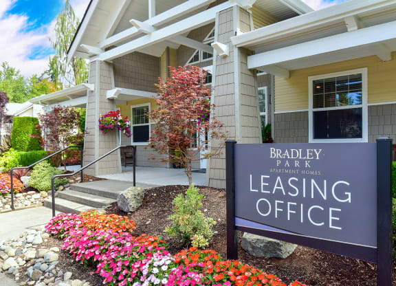 a building with a leasing office sign in front of it