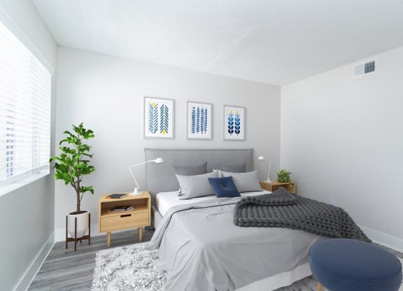 a bedroom with a bed and a chair in a 555 waverly unit