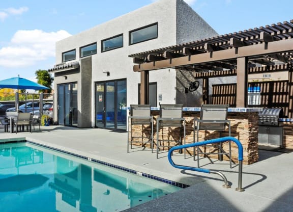 Del Sol Apartments Pool with Lounge Chairs and BBQ Area