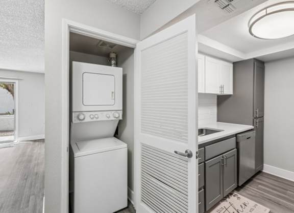 A small kitchen with a white oven and sink.