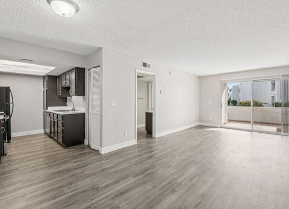 A kitchen area with a refrigerator, microwave, and oven.