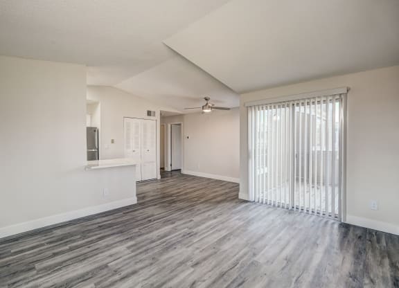 an empty living room with a sliding glass door