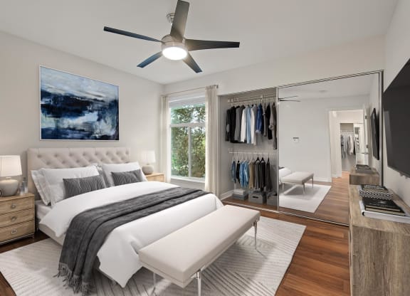 a bedroom with a bed and a ceiling fan