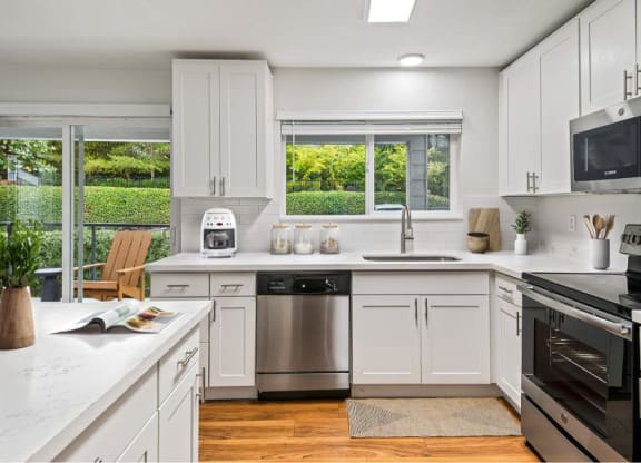 a kitchen with white cabinets and a stainless steel refrigerator