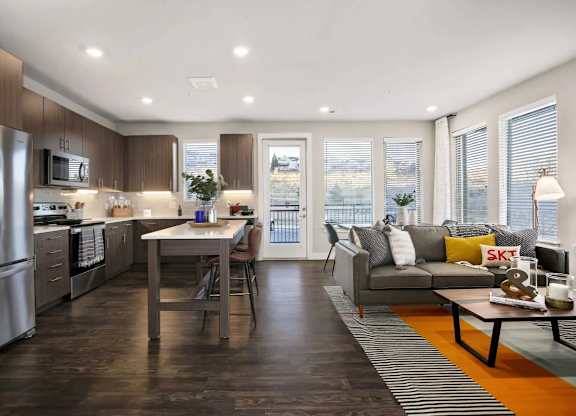 A modern kitchen with a dining table and a couch.