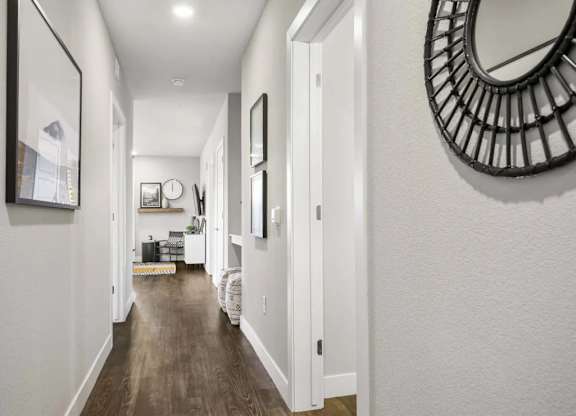 A long hallway with a mirror on the wall.