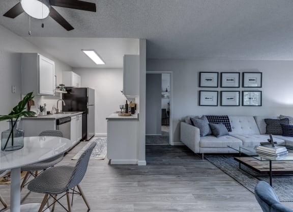 an open concept living room and kitchen in an apartment
