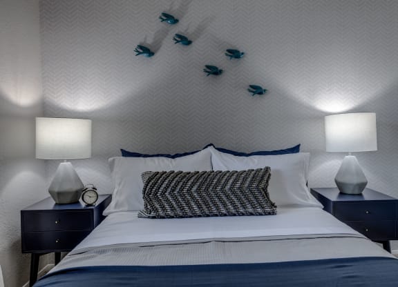 a bedroom with a bed and two night stands with lamps