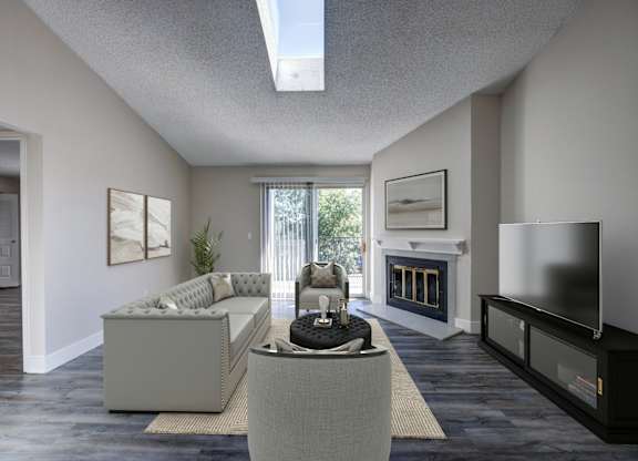 A modern living room with a grey sofa and a fireplace.