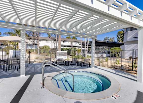 A small round pool under a white roof.