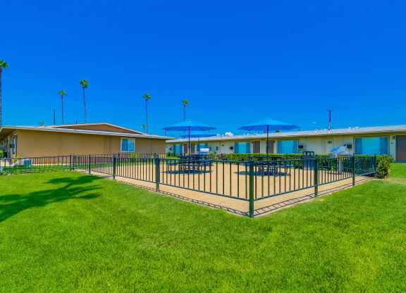 Exterior View of Las Brisas Apartments Building Surrounded By Lush Landscaping with View of Outdoor Picnic Area at Las Brisas Apartments, California