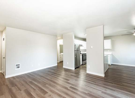 A room with wood flooring and a ceiling fan.