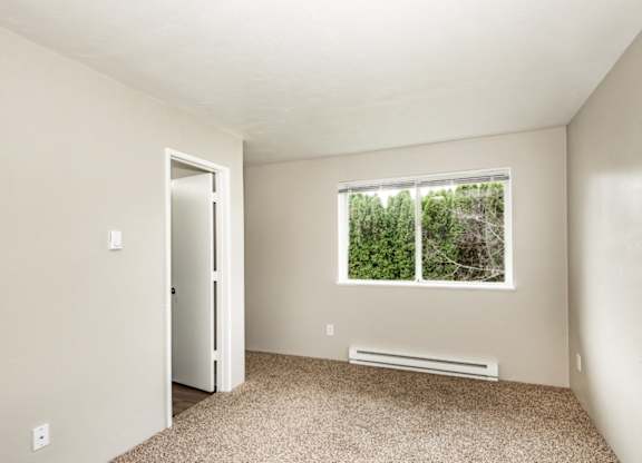 A room with a window and a door.